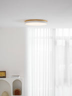 Circular wood ceiling lamp illuminating a hallway with soft white light