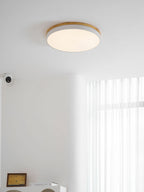 Circular wood ceiling lamp with yellow finish on a ceiling
