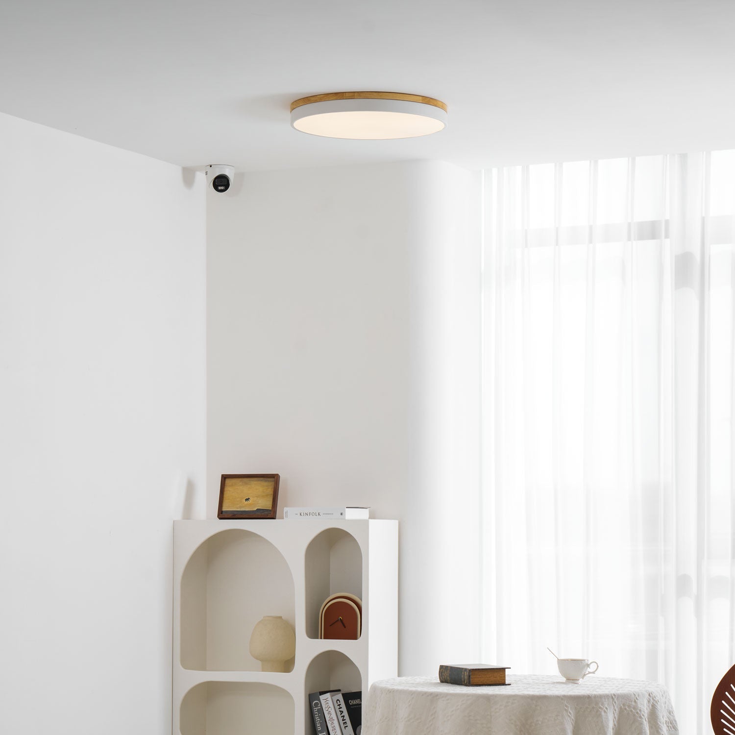 Circular wood ceiling lamp lit warmly in an evening bedroom