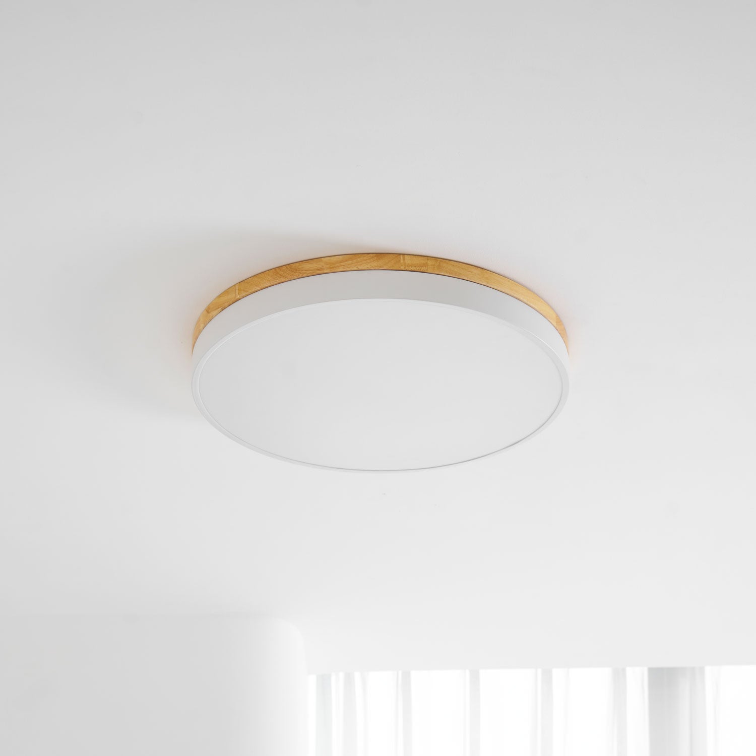 Circular wood ceiling lamp in a calm space with diffused lighting