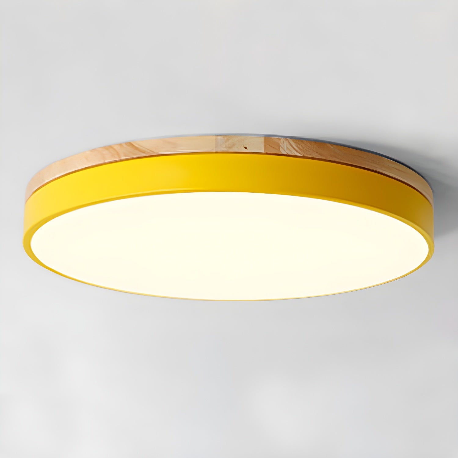 Circular wood ceiling lamp lit with warm diffused light over a living space