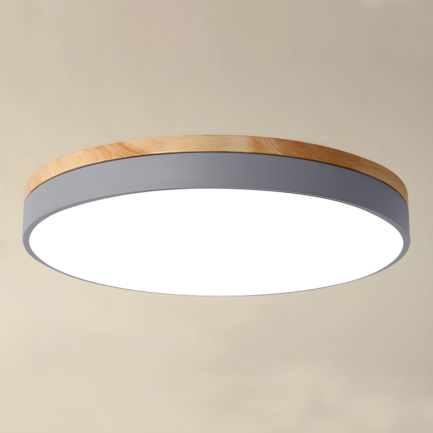 Circular wood ceiling lamp mounted flush against a ceiling, showing its slim disc profile