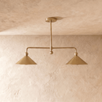 Clérachic chandelier in satin brass, close front-on view of the two angled cone shades and center rod.