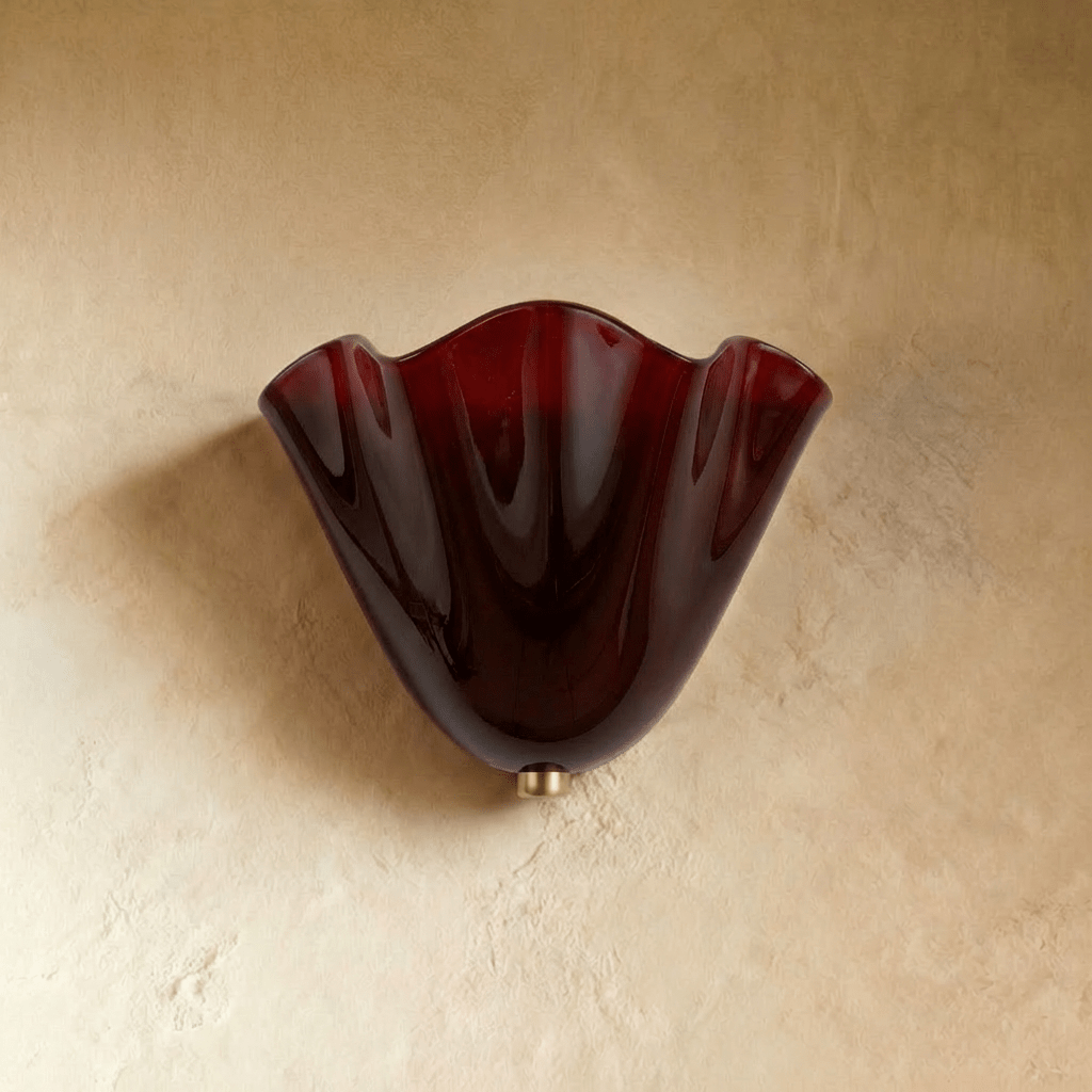Clérachic brown glass wall light lit warm in a dim hallway