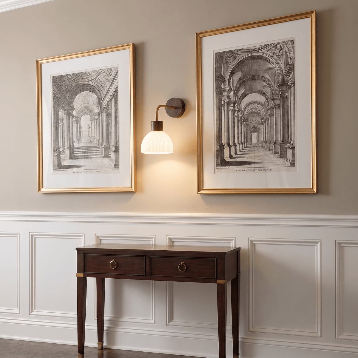This Clérachic wall light glows between two framed architectural prints above a dark wood console table.