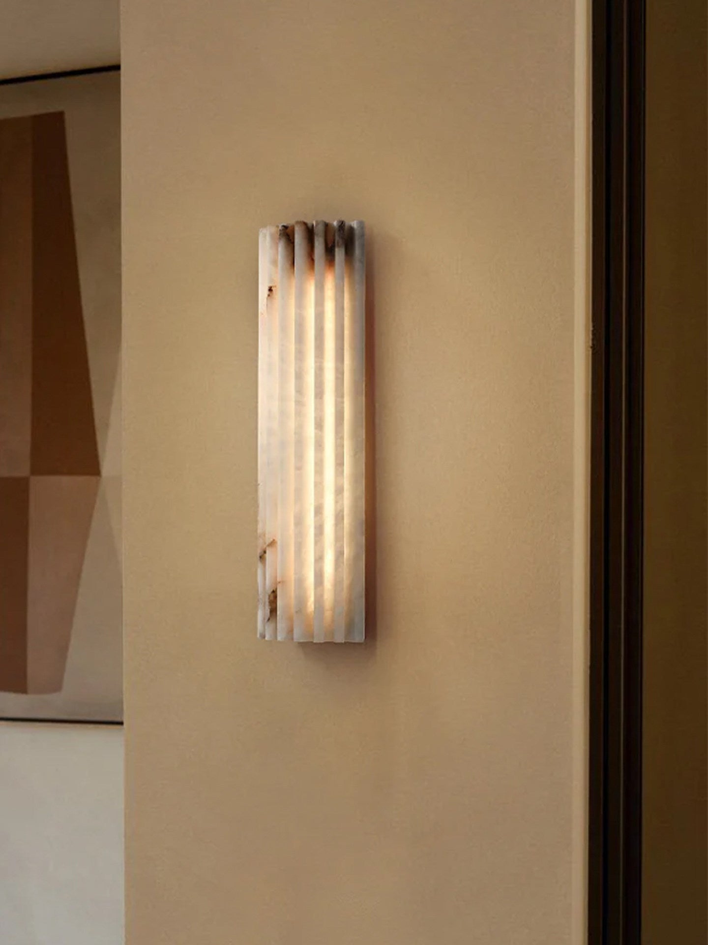 Alabaster wall light shown unlit revealing natural stone tone