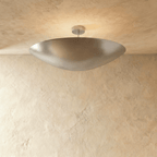 Clérachic ceiling light in a bright chrome finish, its boat-shaped bowl shade set flush against a plaster ceiling.