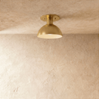 Clérachic ceiling light in a warm satin brass finish, a rounded dome shade set flush to the ceiling.