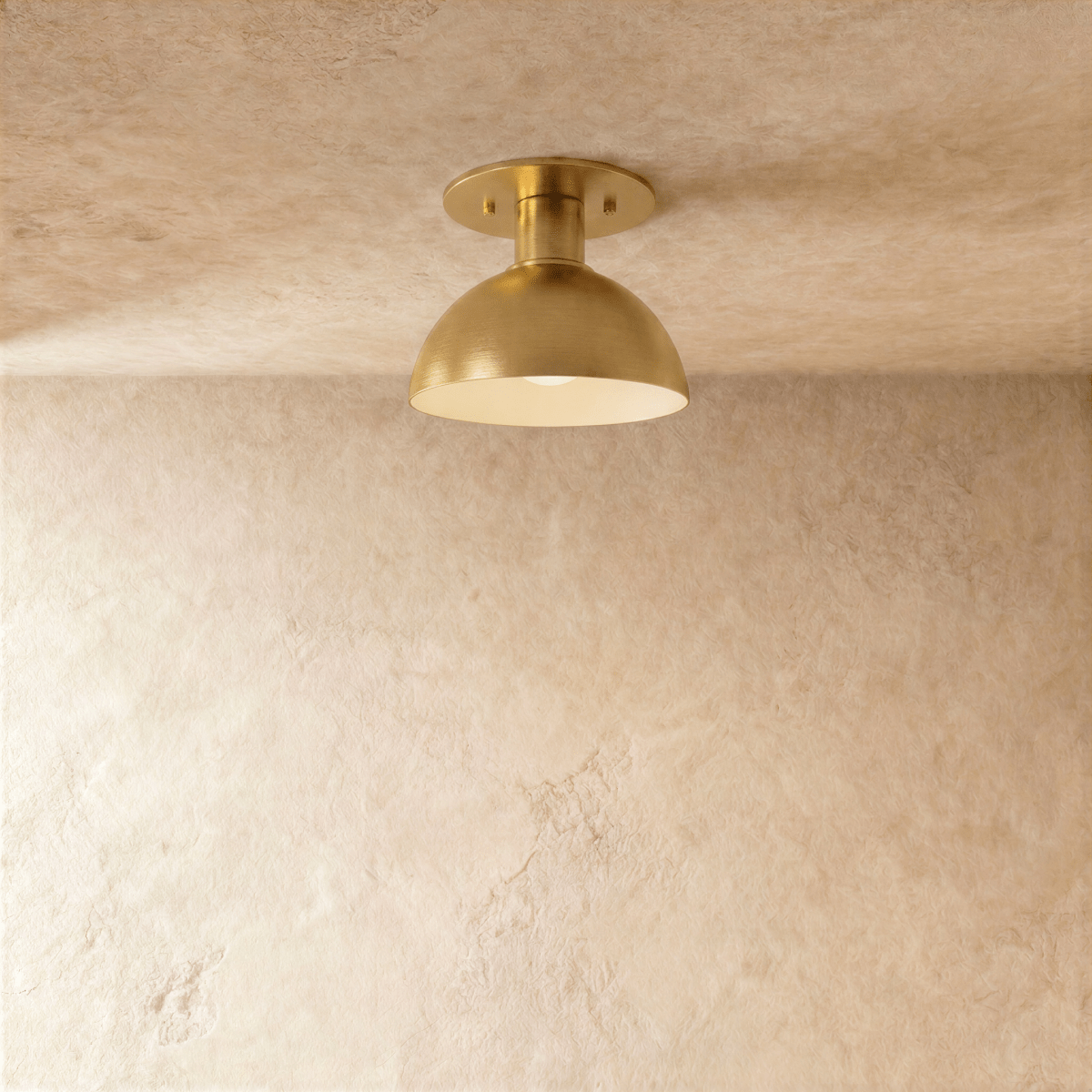 Clérachic ceiling light in a warm satin brass finish, a rounded dome shade set flush to the ceiling.