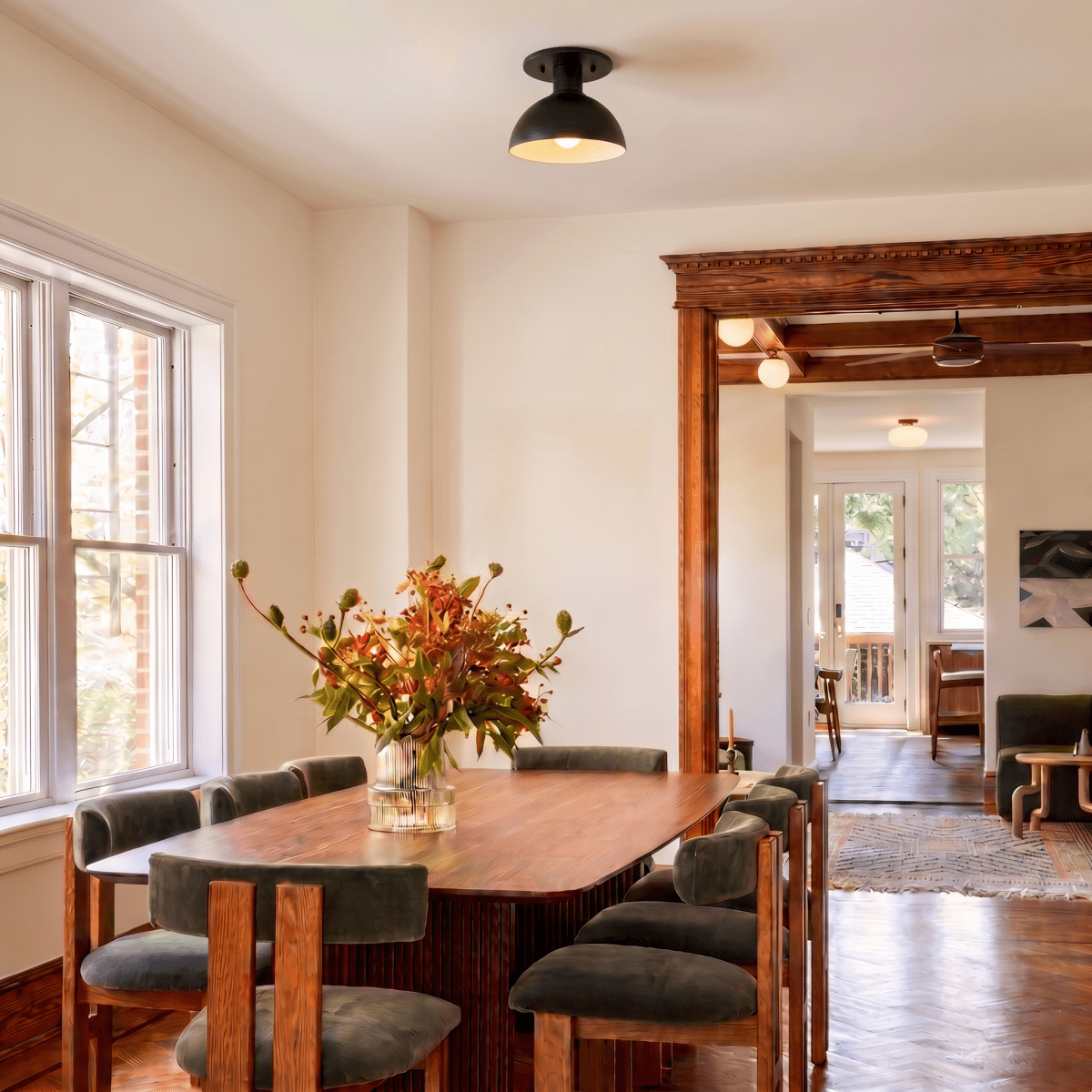 Clérachic ceiling light in matte black over a dining table, seen through a wood-trimmed archway.