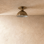 Clérachic ceiling light in vintage brass, close front view of the domed shade and round canopy.