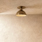 Clérachic ceiling light in vintage brass, a domed metal shade mounted flush against a plaster ceiling.
