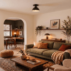 Clérachic ceiling light in matte black glowing above a living room with a green sofa and archway.