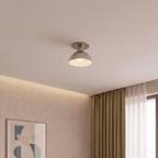 Clérachic ceiling light in chrome mounted in a corner near sheer curtains and a framed abstract print.