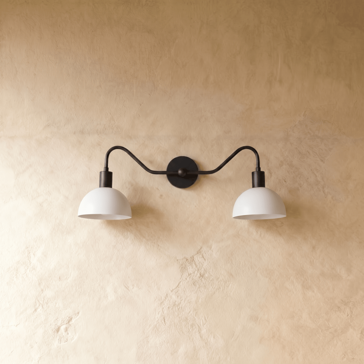 Clérachic twin wall light in black, unlit, the matte dark frame contrasting with the white domes at either end.