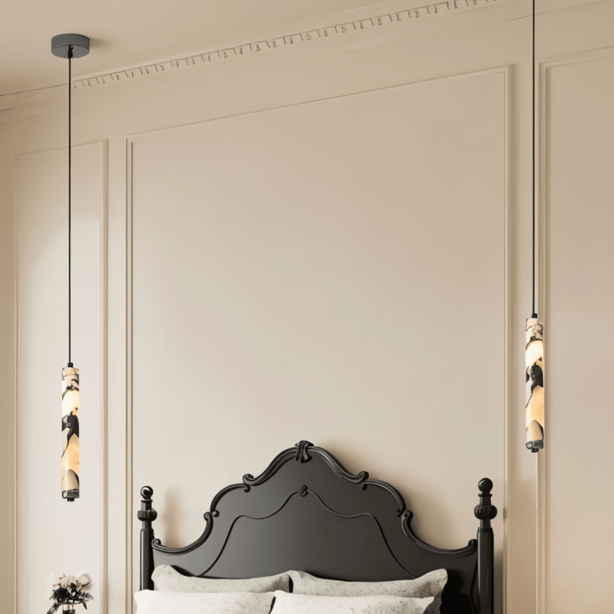 Clérachic marble pendant lights hung as a pair either side of a black carved headboard, with a tick-marked rule running along the cornice above.
