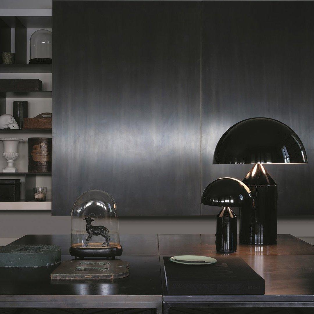 Sculptural metal table lamp lit in an evening interior