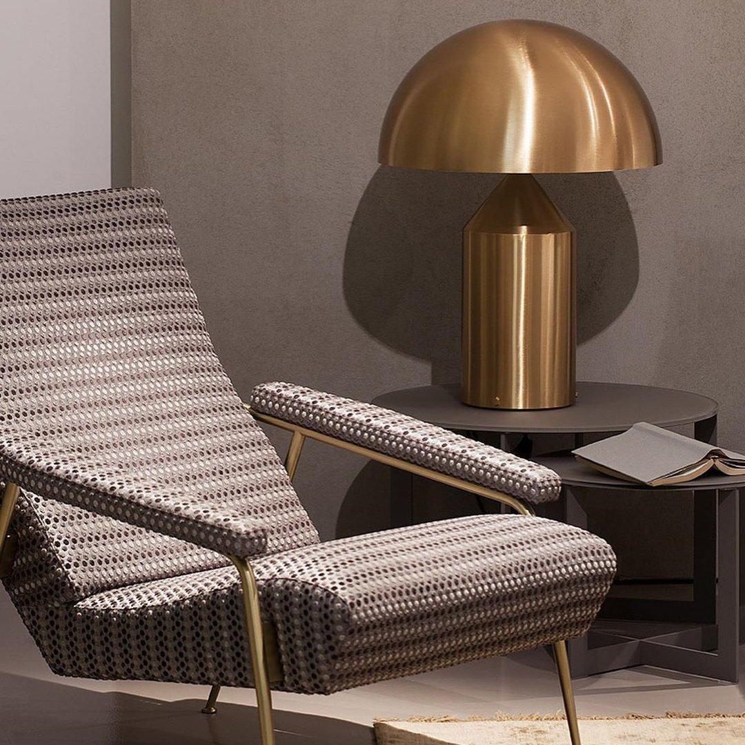 Sculptural metal table lamp styled on a shelf with decor