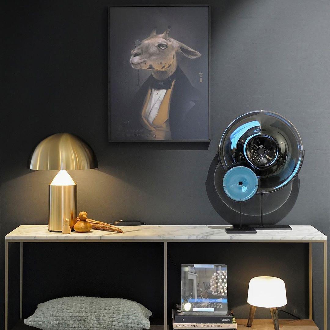 Sculptural metal table lamp glowing in a styled room