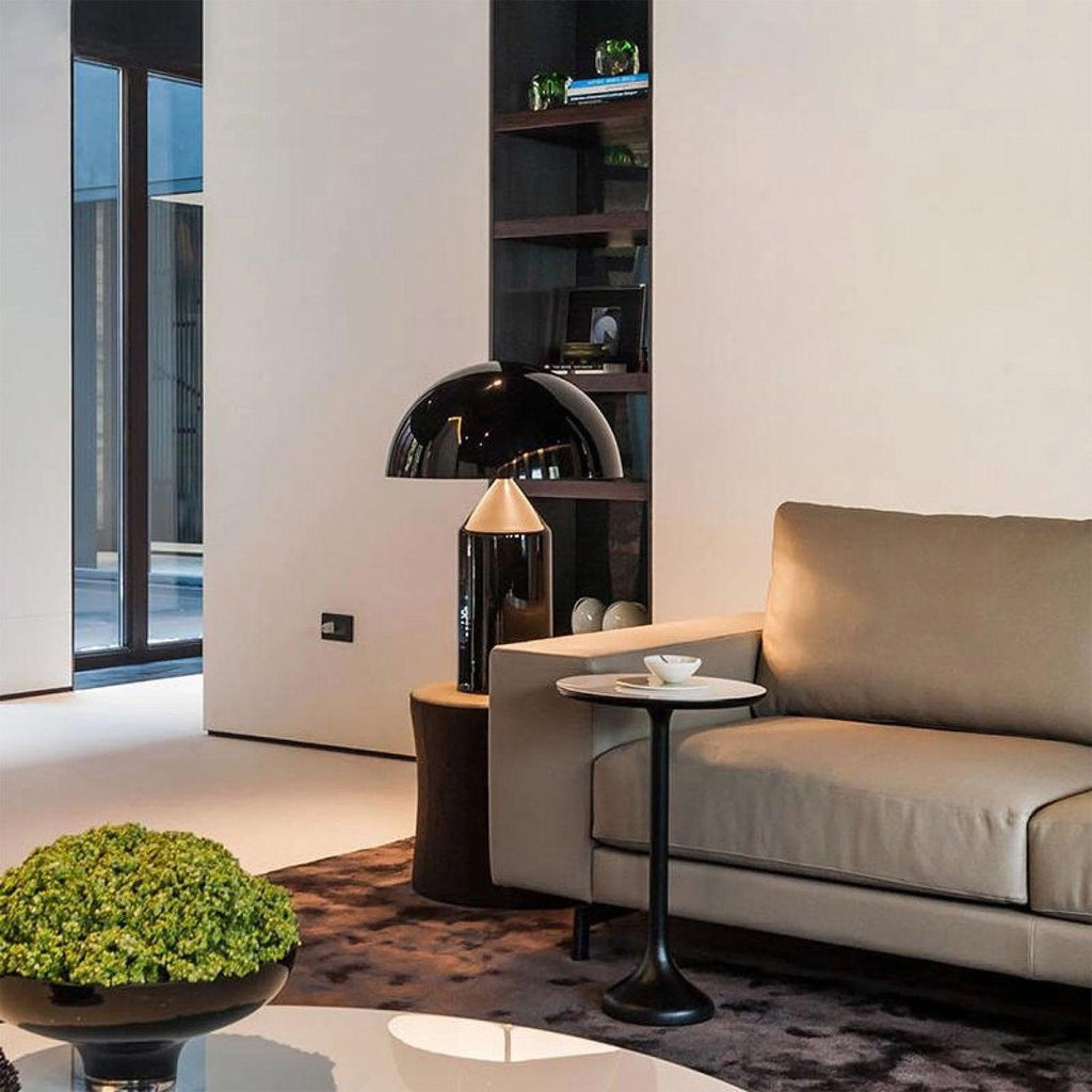Sculptural metal table lamp glowing warmly on a table