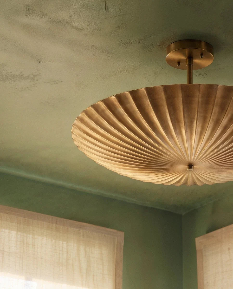 Clérachic pendant light in brass, close view of the fluted shade above a green dining room banquette.