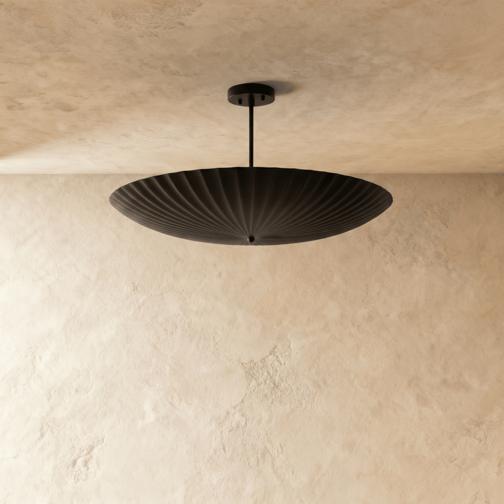 Clérachic pendant light in matte black, close view of the fluted disc shade and mounting canopy.