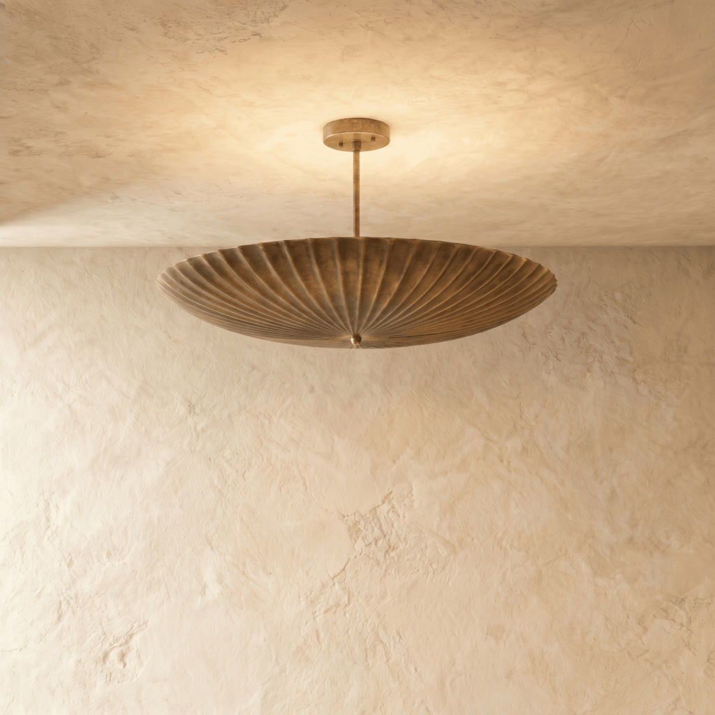 Clérachic pendant light in vintage brass, a fluted disc shade hung flat beneath a slender ceiling rod.