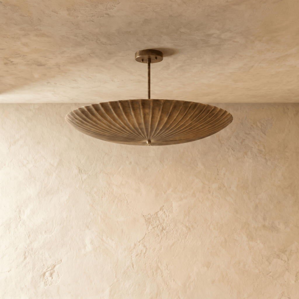 Clérachic pendant light in vintage brass, close view of the fluted disc shade and mounting canopy.