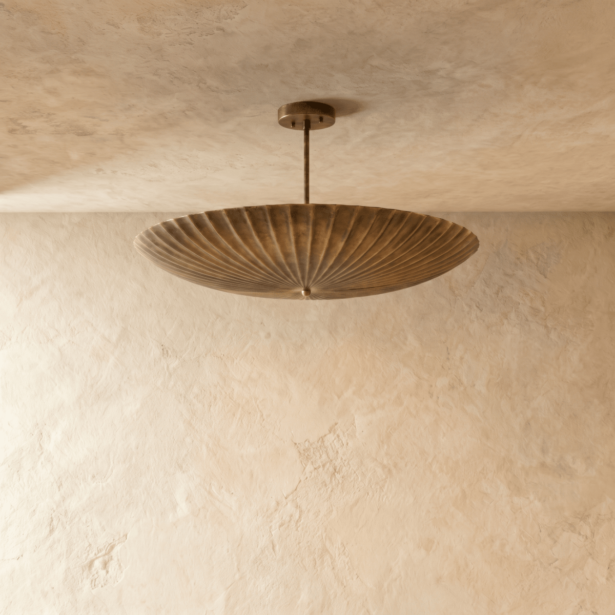 Clérachic pendant light in vintage brass, close view of the fluted disc shade and mounting canopy.