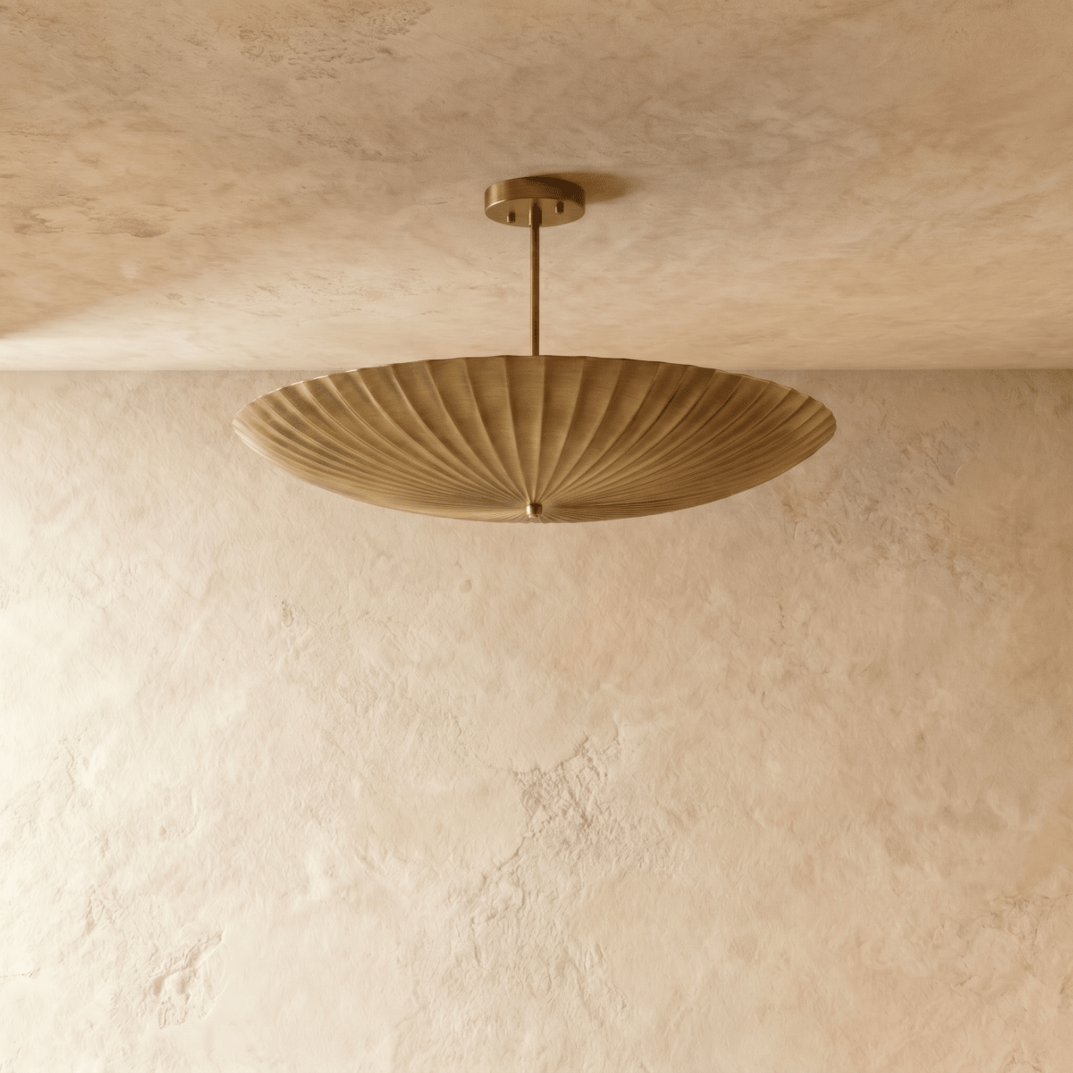 Clérachic pendant light in satin brass, front view of the fluted disc shade and slim ceiling rod.