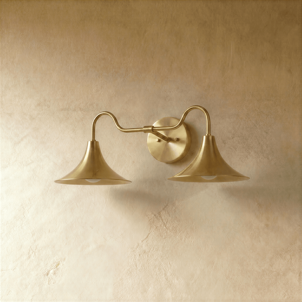 Clérachic double-head wall sconce in polished brass, the trumpet shades and gooseneck arms shown from another angle.