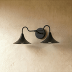 Clérachic double-head wall sconce in matte black, the trumpet shades and gooseneck arms from another angle.