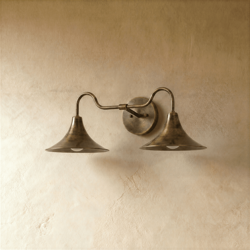 Clérachic double-head wall sconce in vintage brass, the trumpet shades and gooseneck arms from another angle.