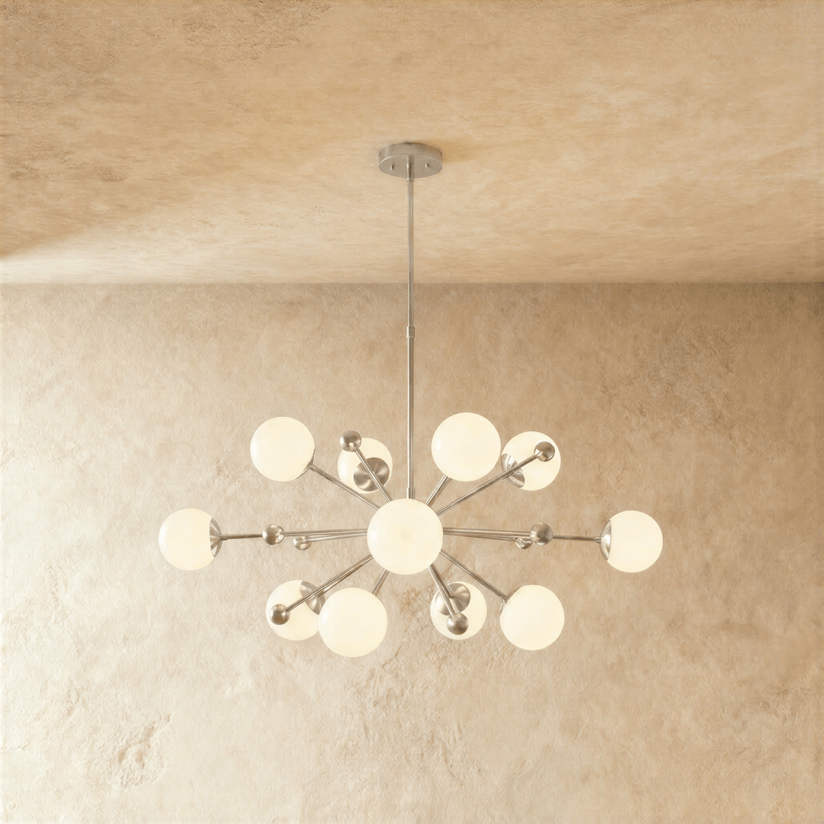 This Clérachic chandelier in chrome, a sputnik burst of opal glass globes on slender arms.