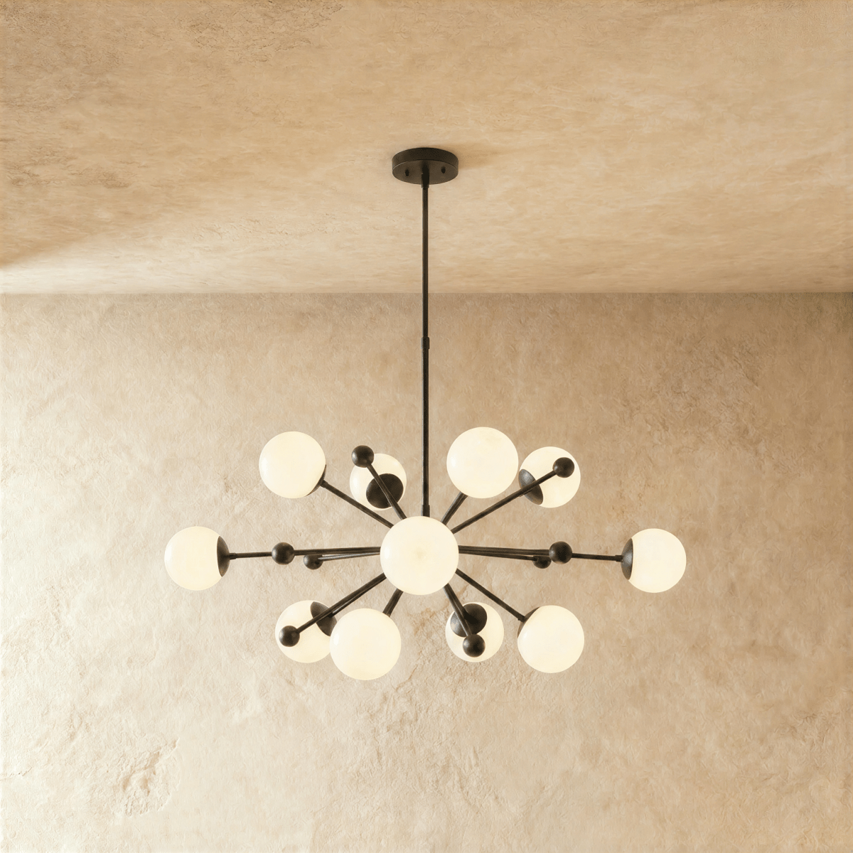Clérachic chandelier in matte black, a sputnik burst of opal glass globes on slender arms.