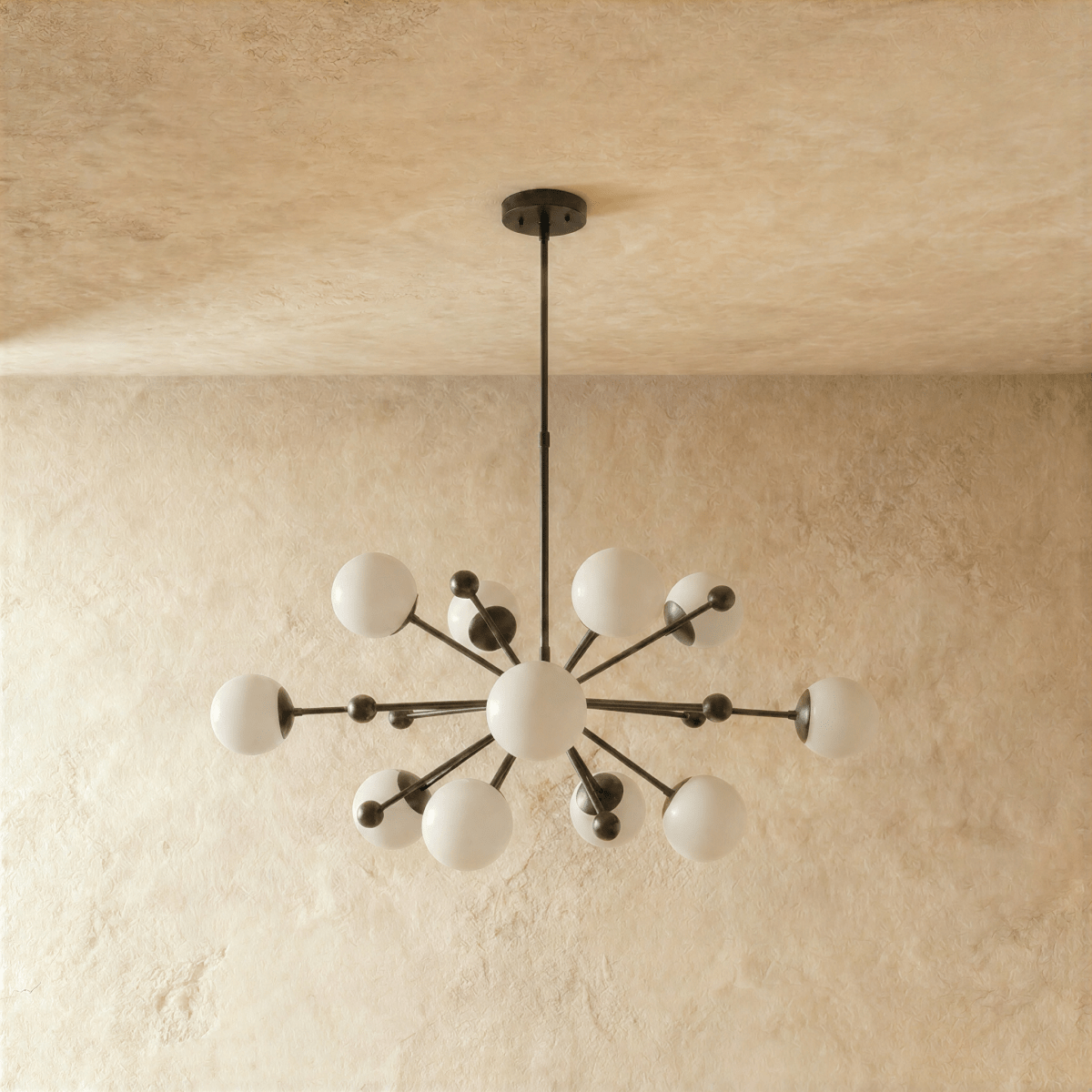 Clérachic chandelier in matte black shown from another angle, globes radiating from a central sphere.