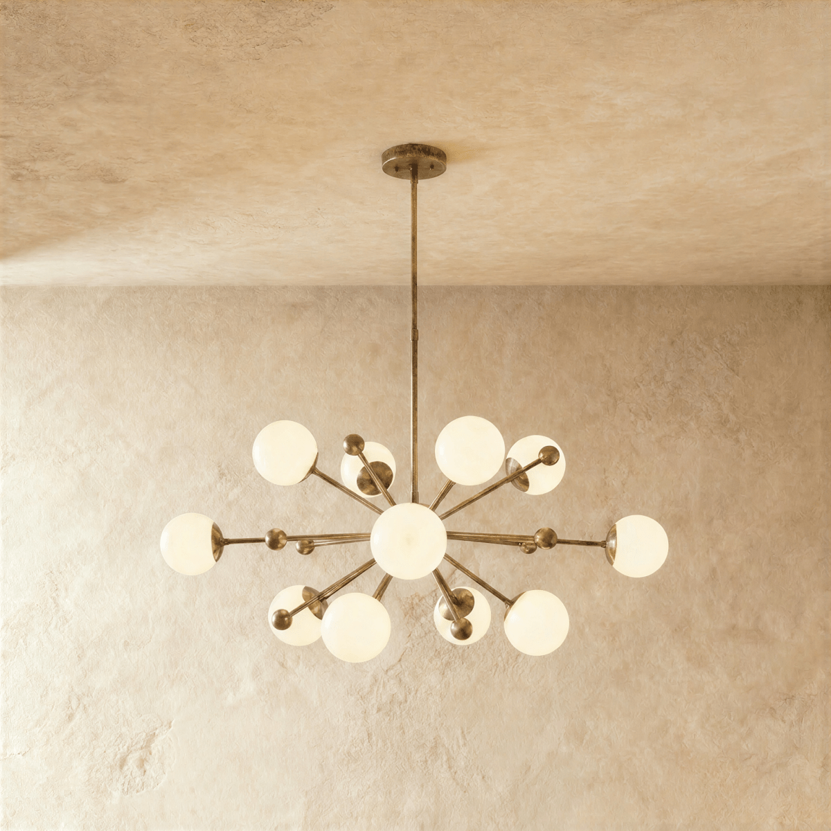 Clérachic chandelier in vintage brass, a sputnik burst of opal glass globes on slender arms.