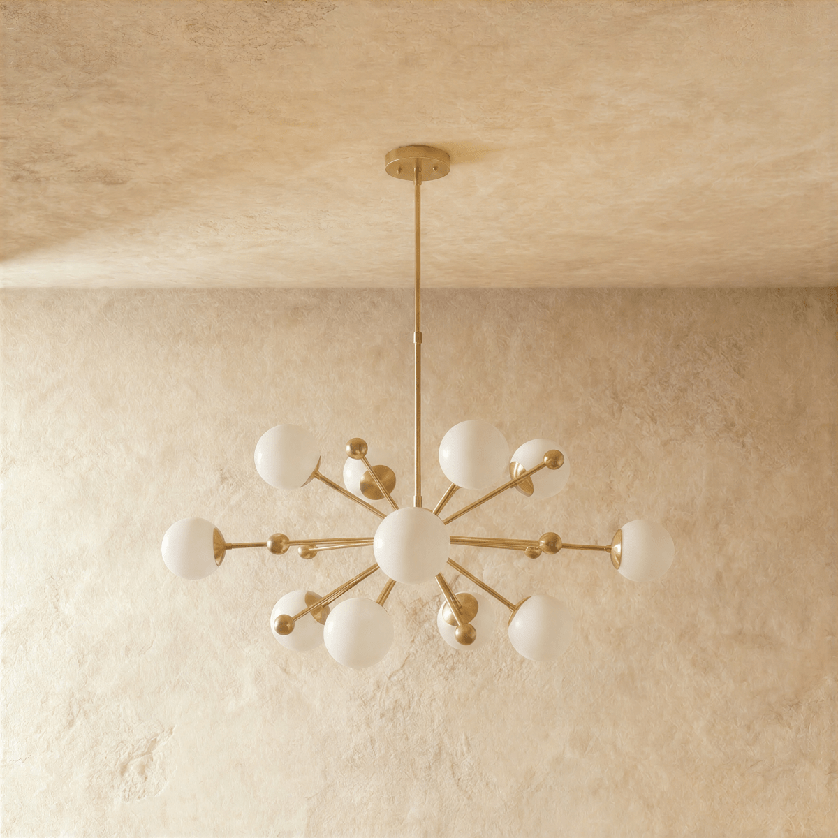 Clérachic chandelier in brushed brass shown from another angle, globes radiating outward from the rod.