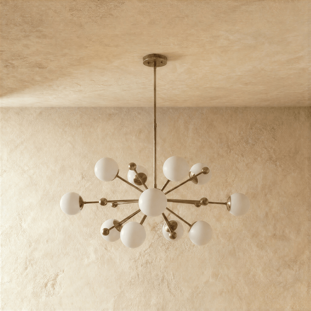 Clérachic chandelier in vintage brass shown from another angle, globes radiating from a central sphere.