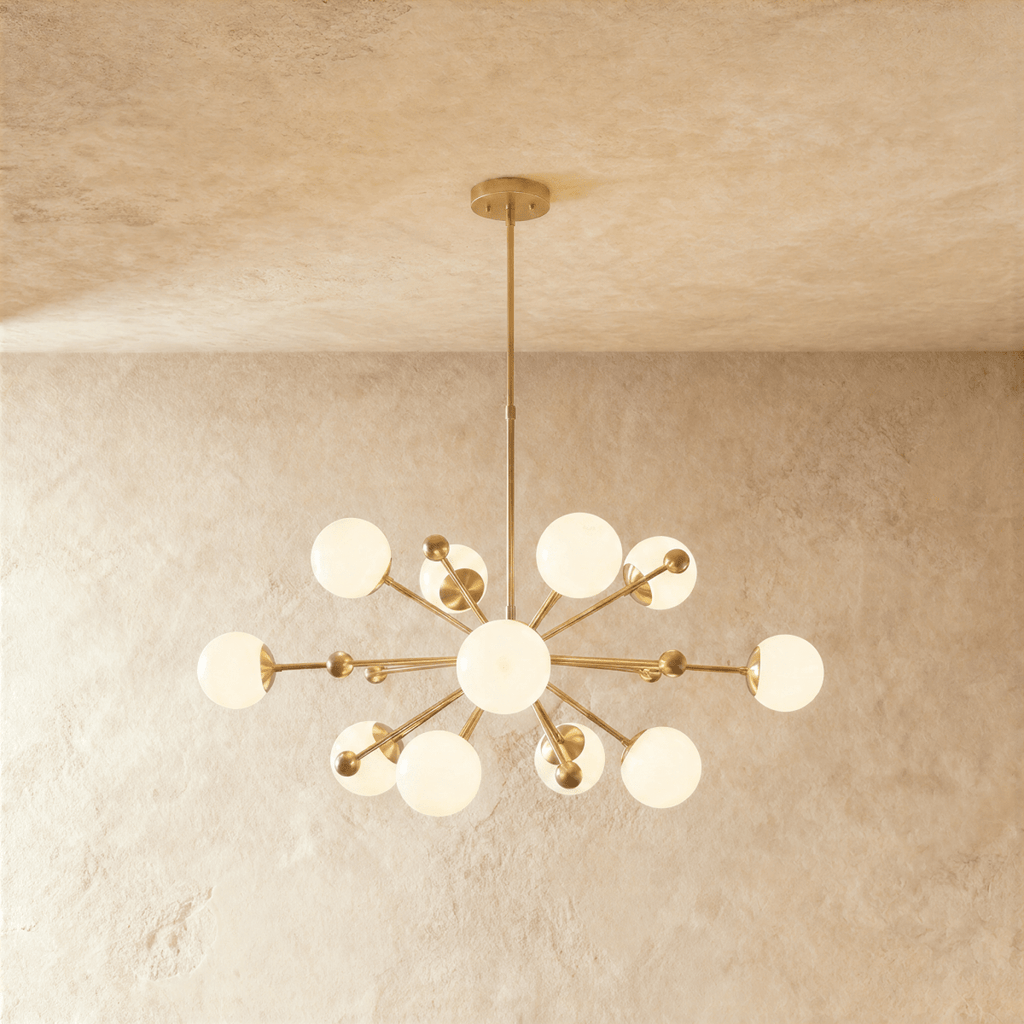 Clérachic chandelier in brushed brass, a sputnik burst of opal glass globes on slender arms.
