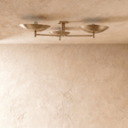 Clérachic ceiling light in vintage brass, close view of the three angled shades and slender arms.