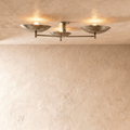 Clérachic ceiling light with three boat-shaped shades on slender arms, lit against a plaster ceiling.