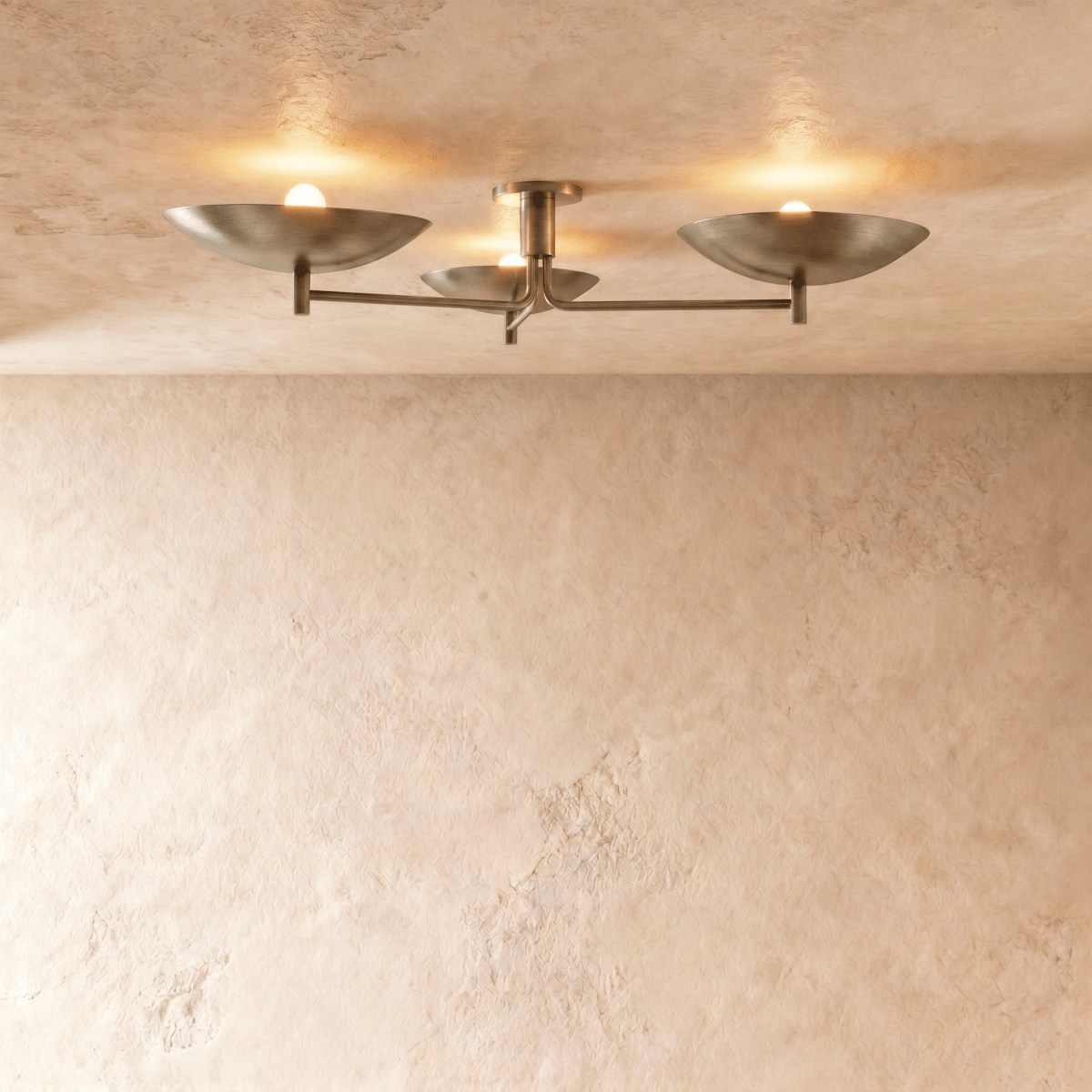 Clérachic ceiling light with three boat-shaped shades on slender arms, lit against a plaster ceiling.