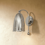 Clérachic wall lamp in chrome, its perforated bell shade suspended from a curved metal arm.