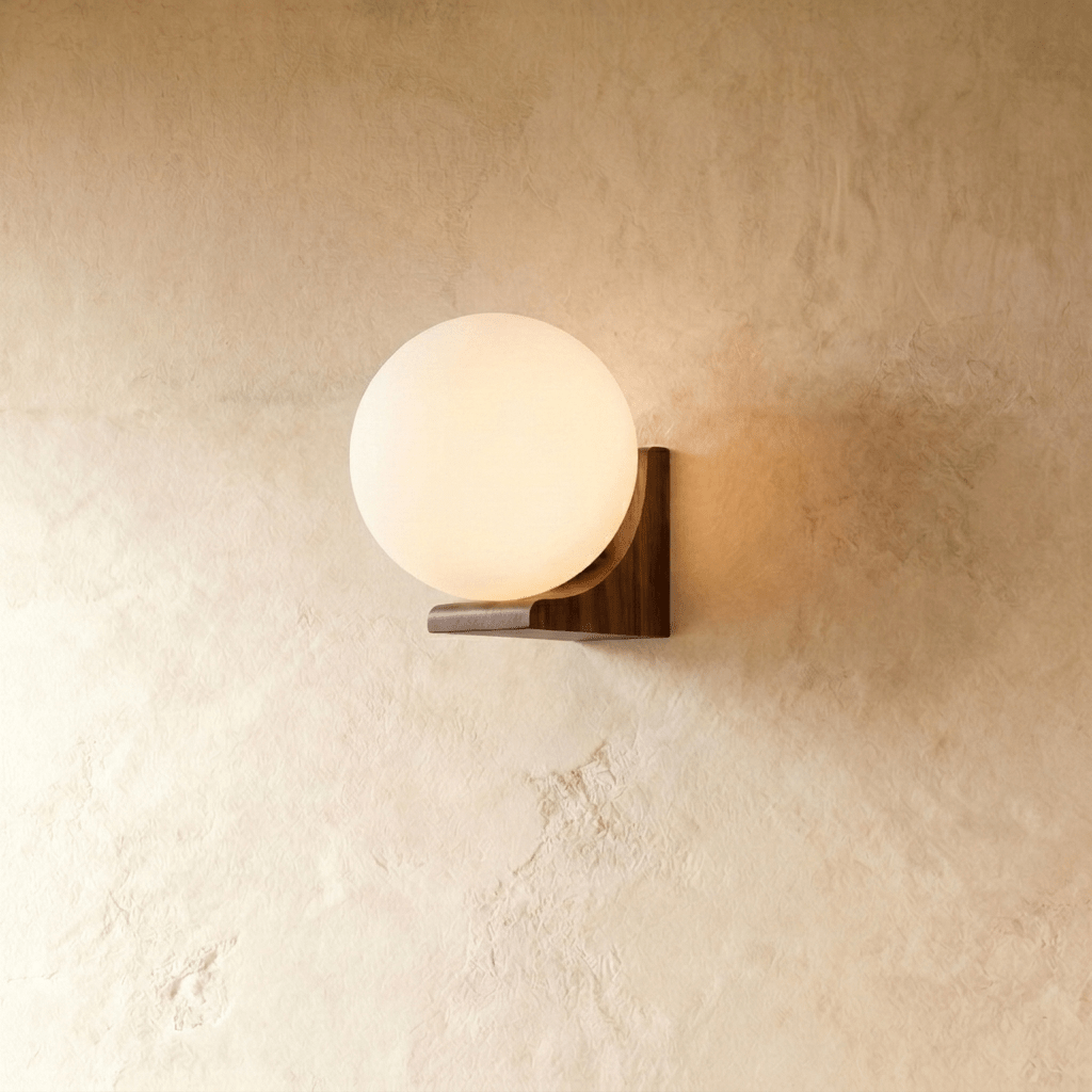 Clérachic globe wall light, opal glass sphere resting against a solid wood block