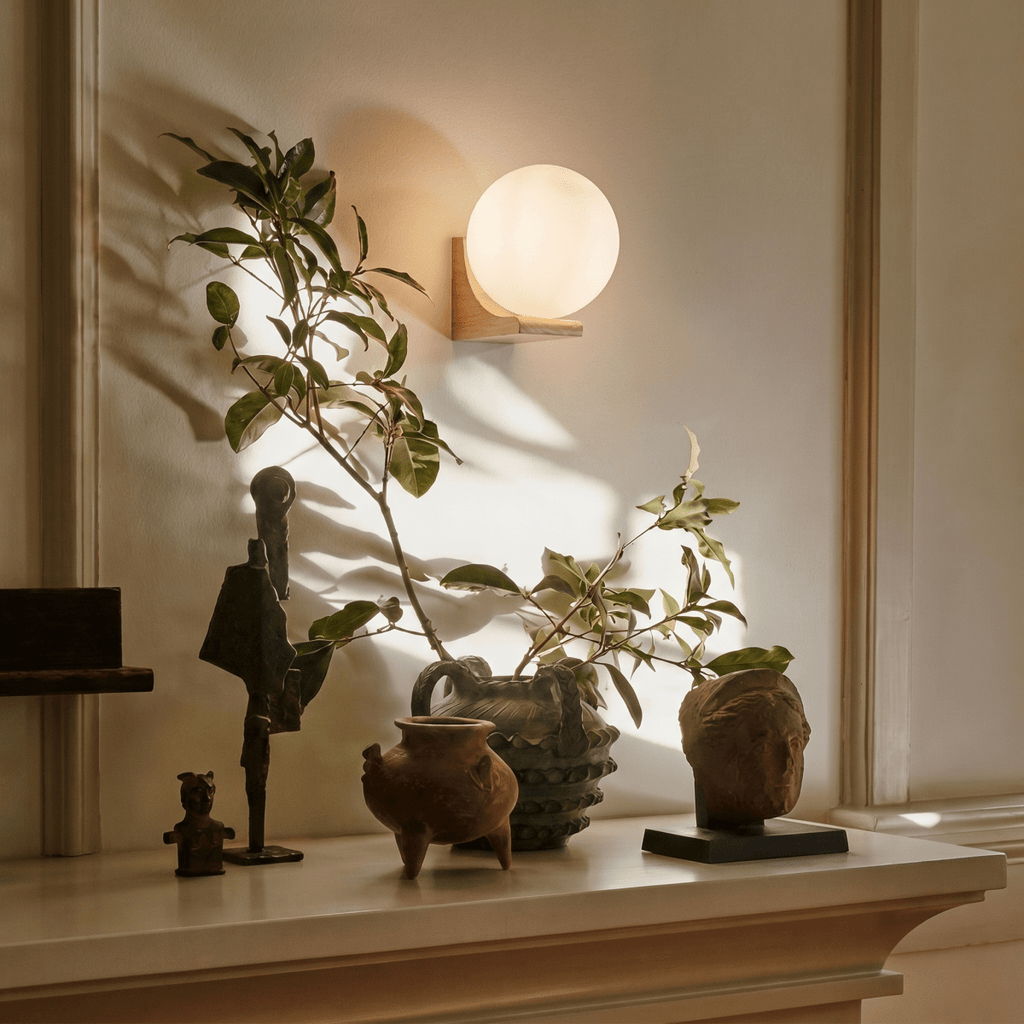 Clérachic globe wall light unlit in walnut, the opal glass reading as plain white