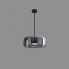 Hand-blown glass pendant light hanging from a slim ceiling rod