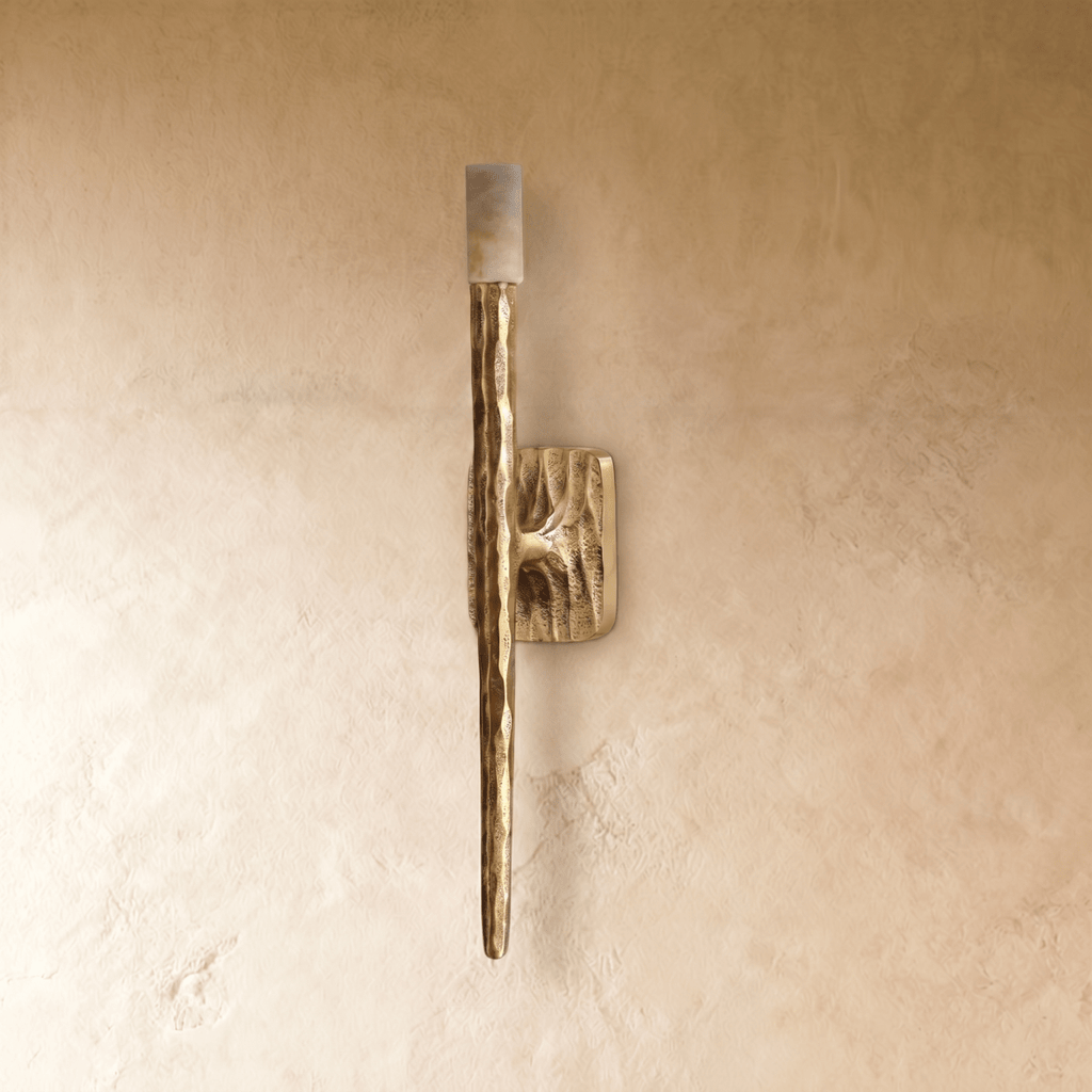 Clérachic wall lamp shown unlit, so the soft tan veining in the stone cap and the rippled relief on the rounded wall plate both read clearly.