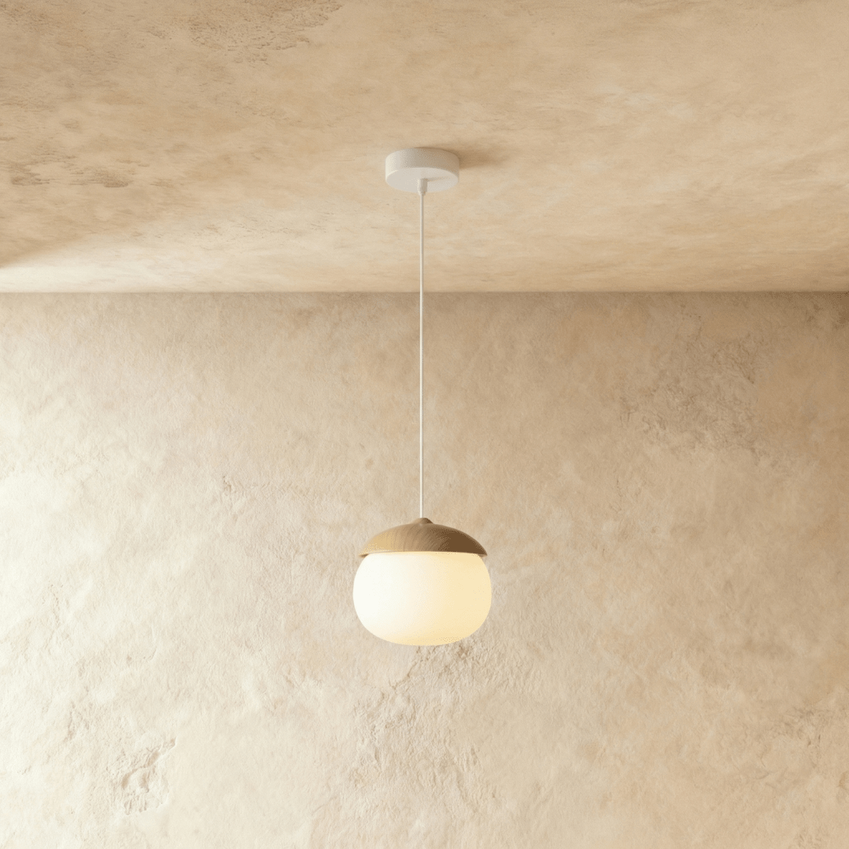 Clérachic wide acorn pendant lit against a limewash wall