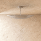 Clérachic ceiling light in chrome, close view of the curved perforated shade and slender rod.